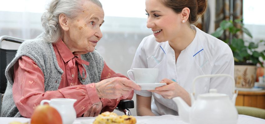 A nurse explaining insurance to a senior.